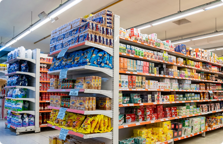 A wide view of a supermarket aisle showcasing various FMCG products on shelves, highlighting promotional and compliance visibility.